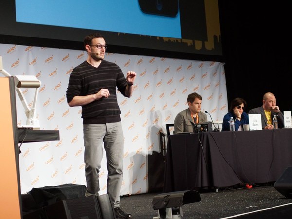 Jerry on stage at Launch Festival with a mic